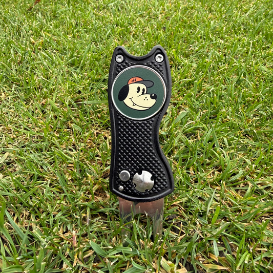 Golf divot tool with cartoon character on grass